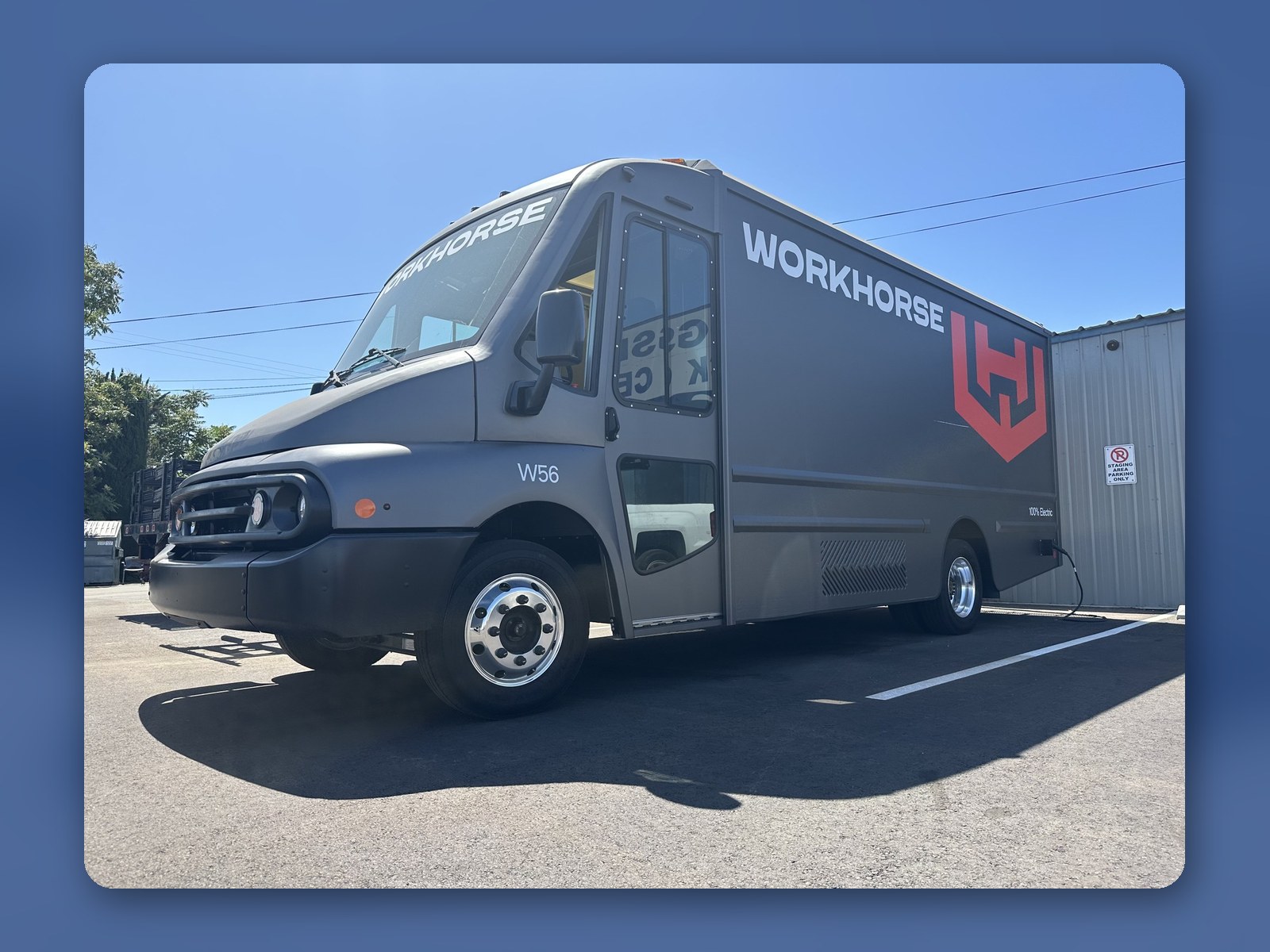 A graphite gray Workhorse W56 electric step van parked in full sun.