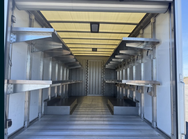Package D Fixed Front / Folding Rear shelving in a Workhorse W56 step van, viewed from the rear door with fixed forward shelving and folding rear sections.
