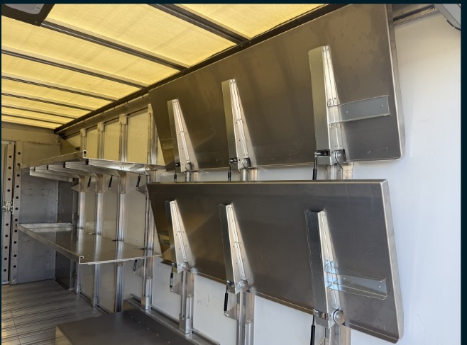 Package D Fixed Front / Folding Rear shelving in a Workhorse W56 step van, close-up of folded rear shelves next to the fixed front section.