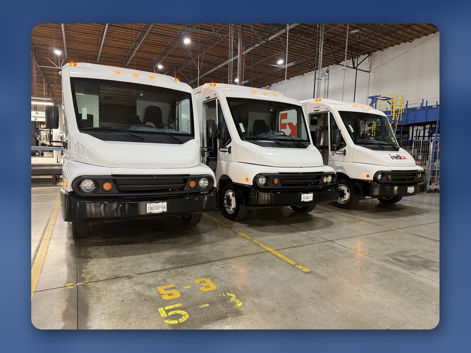 Three new Workhorse W56 step vans parked inside the Kingsburg Truck Center service building.