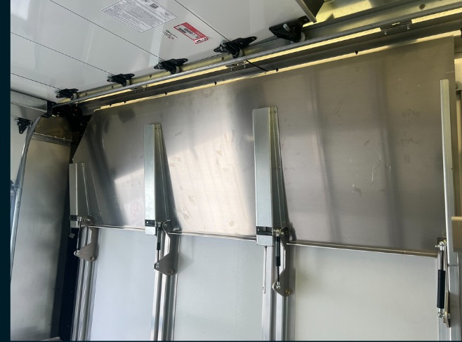 Package B All Folding shelving in a Workhorse W56 step van, upper shelves folded flat against the wall to open headroom.