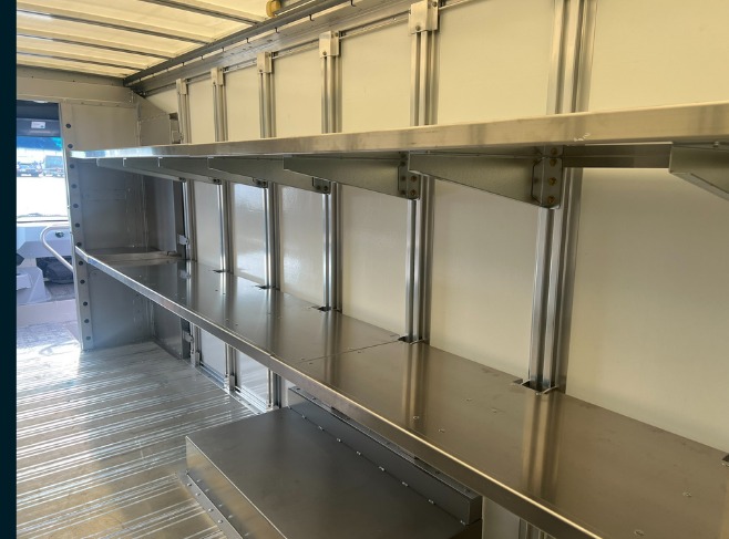 Package A All Fixed shelving in a Workhorse W56 step van, side view of two levels of fixed shelves with vertical support posts.