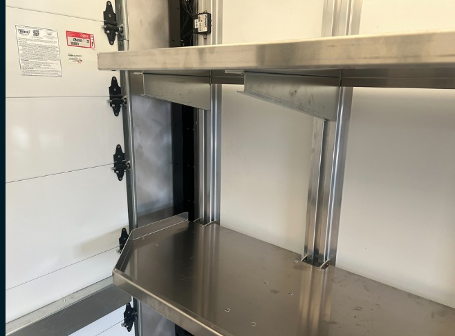 Package A All Fixed shelving in a Workhorse W56 step van, close-up of a fixed shelf bracket and support post at the rear door.