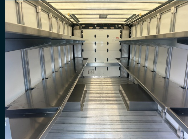Package C Fixed Top / Folding Bottom shelving in a Workhorse W56 step van, fixed upper shelves with the lower level folded away for floor space.