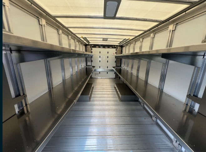Package A All Fixed shelving in a Workhorse W56 step van, looking toward the rear bulkhead with fixed shelves running the length of the body.
