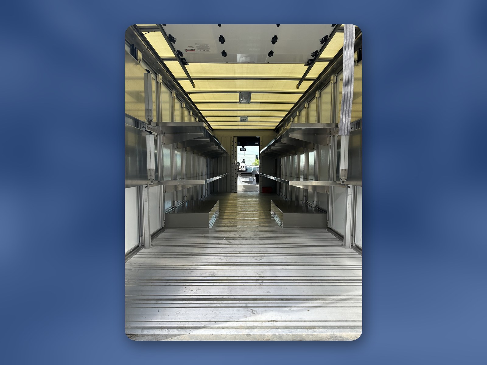 The interior of a W56 cargo box with full-length shelving installed along both walls.